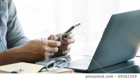 Close up businessman using smart phone at office Close up businessman using smart phone at office 89362569