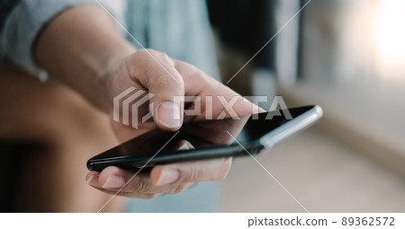 Close up man using smart phone at home Close up man using smart phone at home 89362572