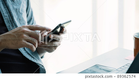 Close up man using smart phone at home Close up man using smart phone at home 89362574