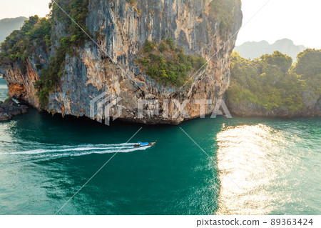 Sea views and rocky islands with a long-tail boat. 89363424