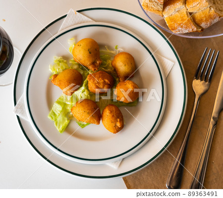 Bunuelos de bacalao - traditional Spanish cod fritters closeup 89363491