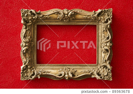 Golden antique forehead hung on a red wall 89363678
