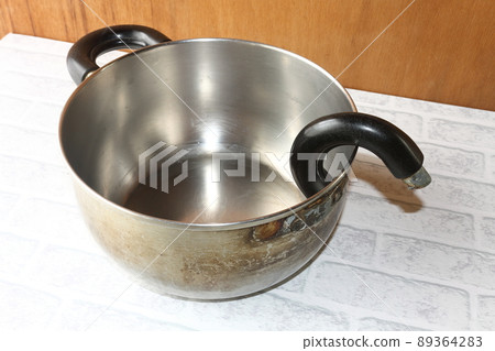 Old pot with a broken handle Old pot with a broken handle 89364283