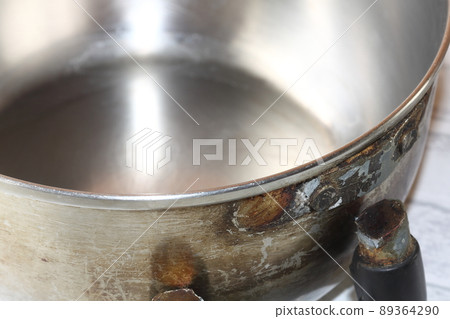 Old pot with a broken handle Old pot with a broken handle 89364290