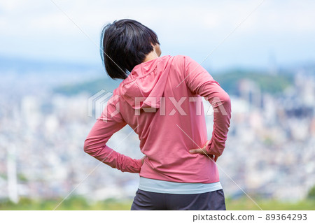 Japanese middle-aged woman exercising outdoors Japanese middle-aged woman exercising outdoors 89364293