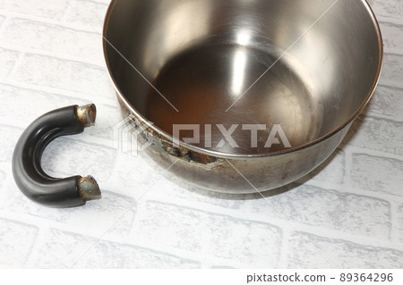 Old pot with a broken handle Old pot with a broken handle 89364296