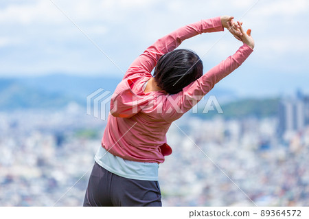 Japanese middle-aged woman exercising outdoors Japanese middle-aged woman exercising outdoors 89364572