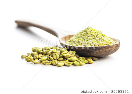 Ground green coffee and coffee beans in wooden spoon. Unroasted coffee isolated on white background. Ground green coffee and coffee beans in wooden spoon. Unroasted coffee isolated on white background. 89365551