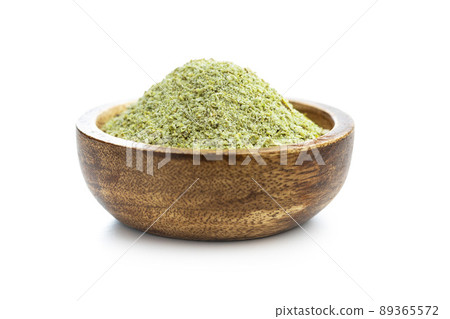 Ground green coffee in wooden bowl. Unroasted coffee isolated on white background. Ground green coffee in wooden bowl. Unroasted coffee isolated on white background. 89365572