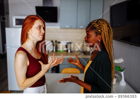 mixed-race same sex couple figuring out the attitude at kitchen mixed-race same sex couple figuring out the attitude at kitchen 89366383