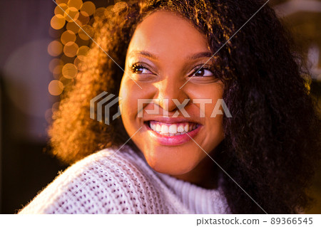 happy woman against the background of a garland of lamps Christmas and New Years concept happy woman against the background of a garland of lamps Christmas and New Years concept 89366545