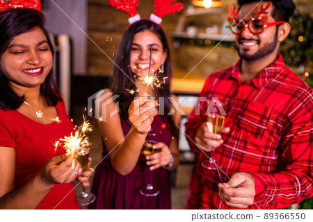 arabian people celebrating Christmas or New Year eve party with Bengal lights ooking happy while having party on the kitchen at stay home quarantine corona virus outbreak party arabian people celebrating Christmas or New Year eve party with Bengal lights ooking happy while having party on the kitchen at stay home quarantine corona virus outbreak party 89366550