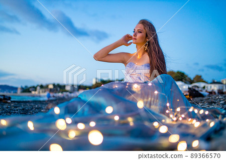 mermaid myth in sunset on beach shore with fish star shells pearls earrings jewelry 89366570