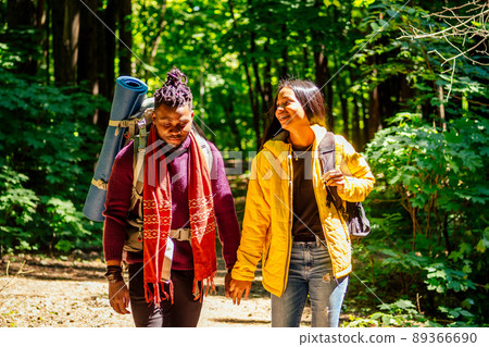latin american man and hispanic woman in a forest having a rest latin american man and hispanic woman in a forest having a rest 89366690
