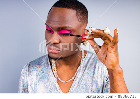 african american visagist with pearl ring on the finger and necklace beads bijouterie on the neck wearing stylish shiny women dress with magnificent mascara makeup african american visagist with pearl ring on the finger and necklace beads bijouterie on the neck wearing stylish shiny women dress with magnificent mascara makeup 89366715