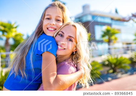 blonde mom and her cute child in summer beach seaside in tropics 89366845