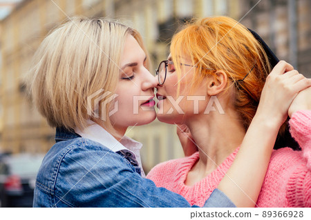 two cheerful same sex people in love walking outdoors in Europe 89366928