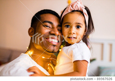 mixed race family spending holiday in the bed in bedroom christmas morning mixed race family spending holiday in the bed in bedroom christmas morning 89367026