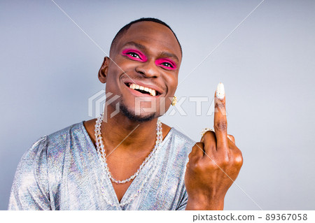 african american with pearl ring on the finger and necklace beads bijouterie on the neck wearing stylish shiny women dress with magnificent makeup making a damn gesture with happy look african american with pearl ring on the finger and necklace beads bijouterie on the neck wearing stylish shiny women dress with magnificent makeup making a damn gesture with happy look 89367058