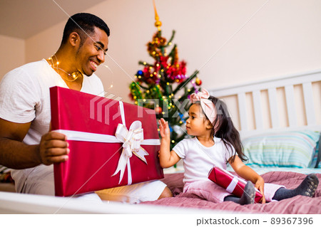 mixed race family spending holiday in the bed in bedroom christmas morning mixed race family spending holiday in the bed in bedroom christmas morning 89367396