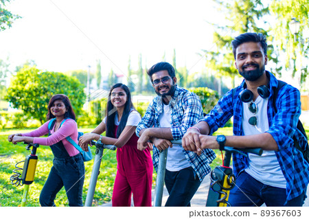 modern indian friends ride on segway in park in India modern indian friends ride on segway in park in India 89367603