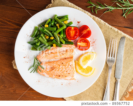Fish salmon steamed with vegetables. Healthy diet food, dark wooden backdrop Fish salmon steamed with vegetables. Healthy diet food, dark wooden backdrop 89367752