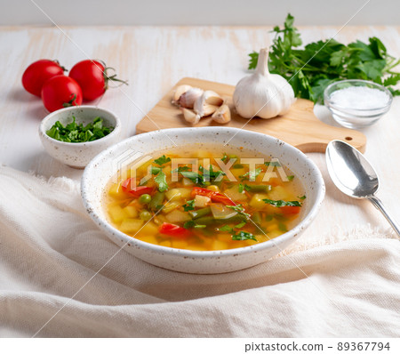 Healthy spring vegetable dietary vegetarian soup, white wooden background, side view, close up 89367794