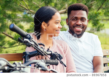 Vietnamese woman and african american man taking a bike for rent Vietnamese woman and african american man taking a bike for rent 89367858