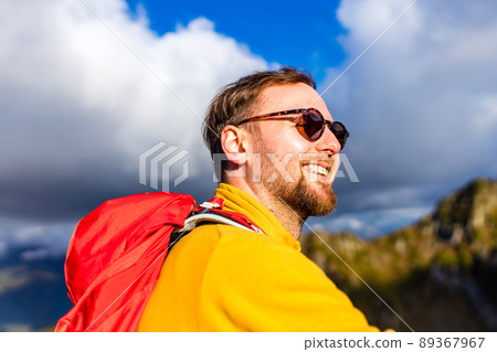 snow white smiling man with braces in mountains . concept of teeth care far from home 89367967