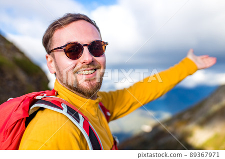 snow white smiling man with braces in mountains . concept of teeth care far from home 89367971