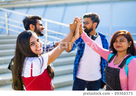 indian students keeping distance and do home work outdoors indian students keeping distance and do home work outdoors 89368373