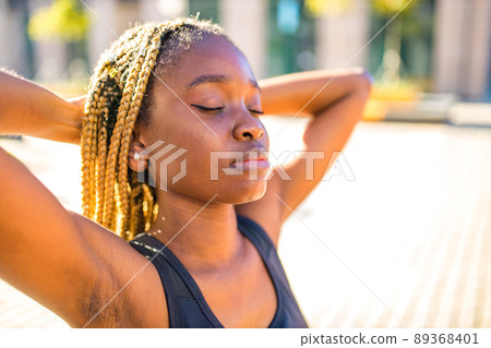 latin brazilian woman in yellow hoody with yellow pigtails dreadlocks in the street took to the public park and streets to protest feminism latin brazilian woman in yellow hoody with yellow pigtails dreadlocks in the street took to the public park and streets to protest feminism 89368401