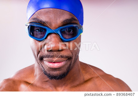afro latin mixed race man swimmer getting ready to start swimming isolated on white background in studio 89368407