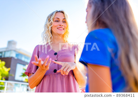 mother talking with her child about plans on day in summer park 89368411