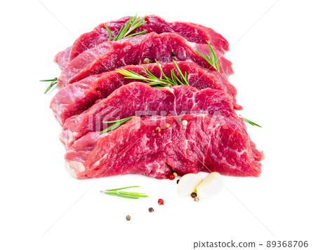 Raw meat, beef steak with seasoning on white background, side view Raw meat, beef steak with seasoning on white background, side view 89368706