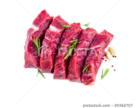 Raw meat, beef steak with seasoning on white background, top view Raw meat, beef steak with seasoning on white background, top view 89368707