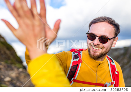 snow white smiling man with braces in mountains . concept of teeth care far from home 89368708