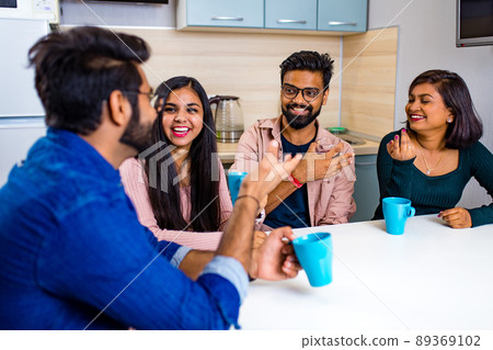 arabian men and women sitting in kitchen and discussing a news arabian men and women sitting in kitchen and discussing a news 89369102