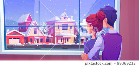 Couple looking at window at snowfall on street 89369232