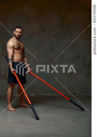 An Experienced Fighter Man, Works Out a Combat Movement with a Long Bamboo  Fighting Stick. Stock Photo - Image of block, japanese: 106320222