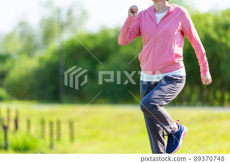 Japanese middle-aged woman exercising in an outdoor park 89370748