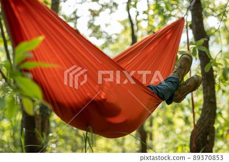 Relaxing in hammock in tropical forest Relaxing in hammock in tropical forest 89370853