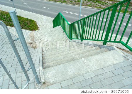 Concrete steps with railing down the street 89371005