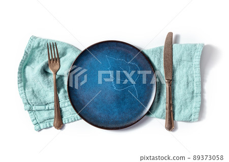 Cutlery with a blue plate with a leaf design. A fork, a knife, and a dish 89373058