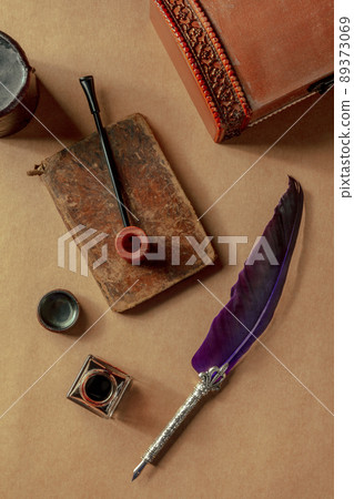 Vintage pipe, notebook, a quill pen, and an ink well. Private detective Vintage pipe, notebook, a quill pen, and an ink well. Private detective 89373069