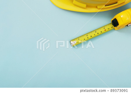 yellow tape measure background in the project at construction site building on concrete floor on city with sunlight. tool for workman as engineer or worker. yellow tape measure background in the project at construction site building on concrete floor on city with sunlight. tool for workman as engineer or worker. 89373091