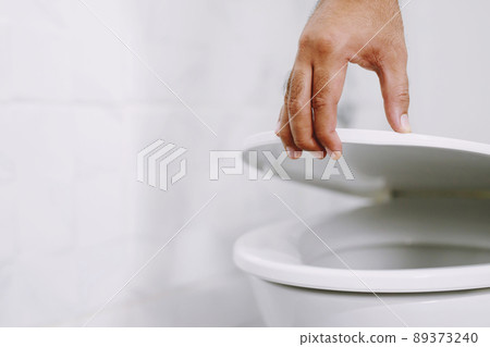 man's hand opening the toilet lid man's hand opening the toilet lid 89373240