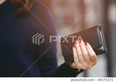 woman person holding a wallet in the hand. Cost control expenses shopping in concept. Leave space to write descriptive text woman person holding a wallet in the hand. Cost control expenses shopping in concept. Leave space to write descriptive text 89373271
