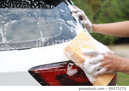 people worker man holding hand yellow sponge and bubble foam cleanser window for washing car. Concept car wash clean. Leave space for writing messages. people worker man holding hand yellow sponge and bubble foam cleanser window for washing car. Concept car wash clean. Leave space for writing messages. 89373279