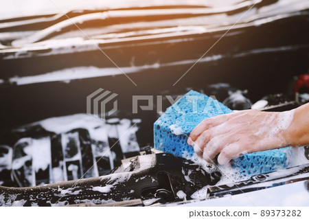 people worker man holding hand blue sponge and bubble foam cleanser window for washing car. Concept car wash clean. Leave space for writing messages. people worker man holding hand blue sponge and bubble foam cleanser window for washing car. Concept car wash clean. Leave space for writing messages. 89373282